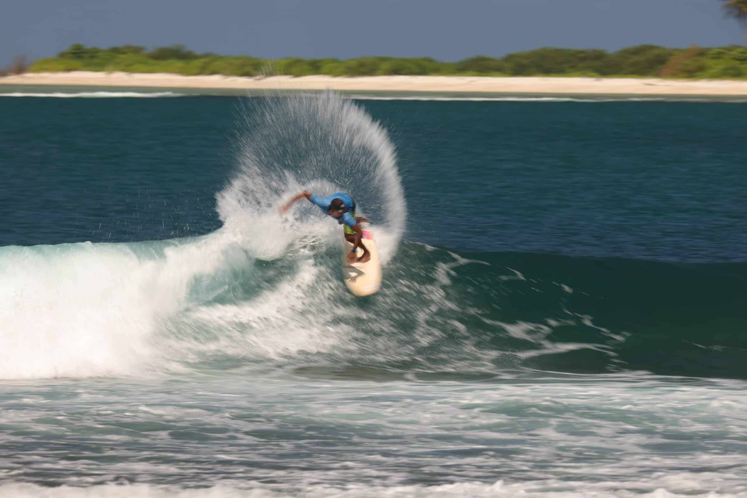 Surfer carving a wave during advanced coaching in Bali