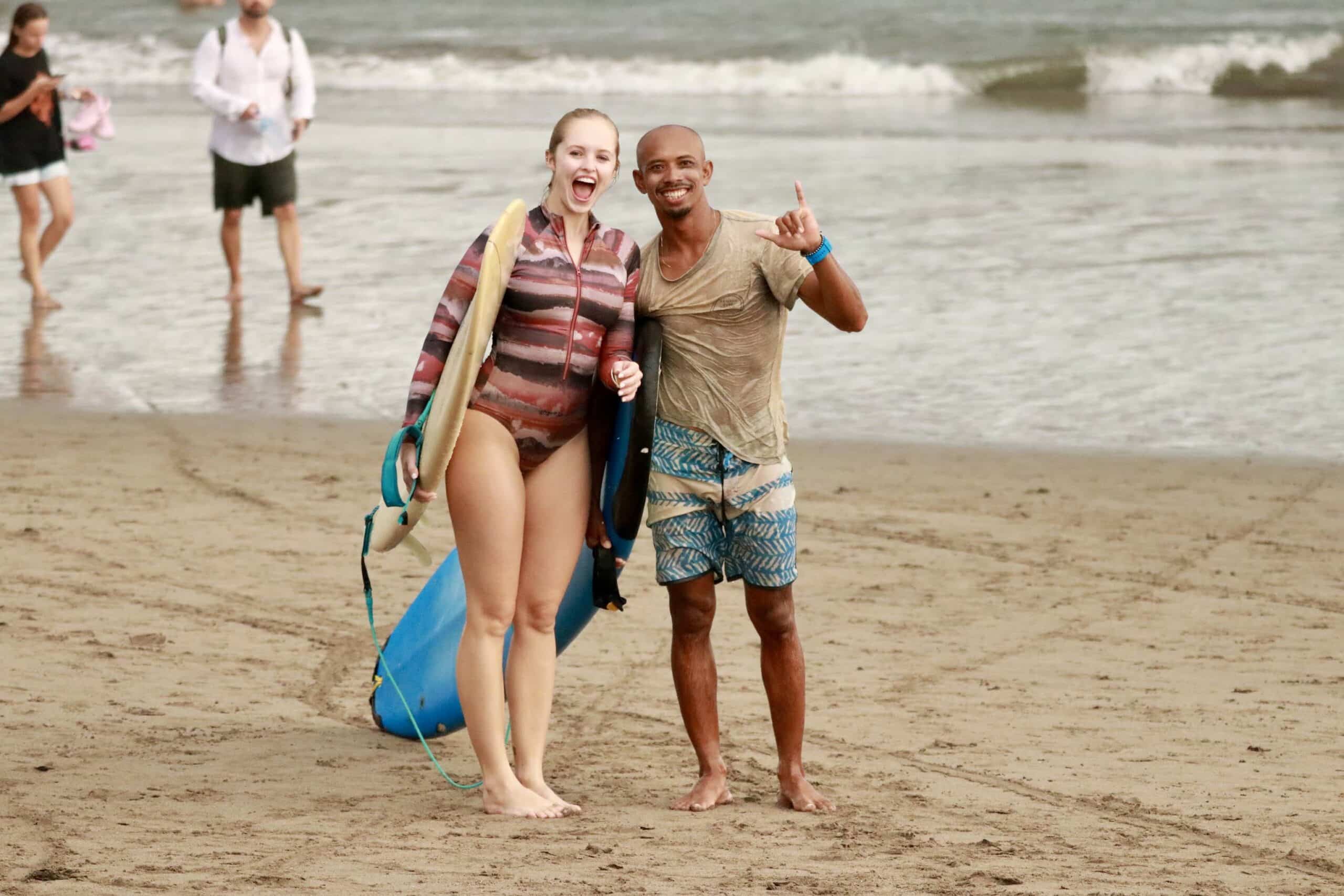 Agus with two surf students and boards on the beach in Medewi