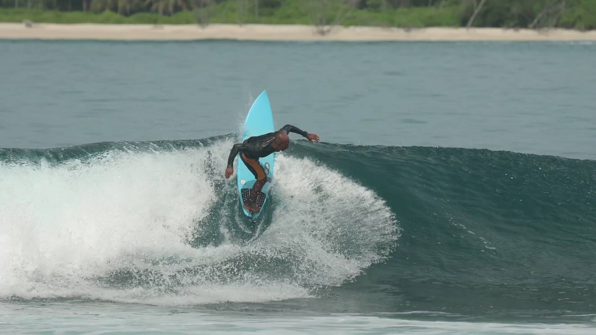 Agus surfing during a guided surf trip in Indonesia